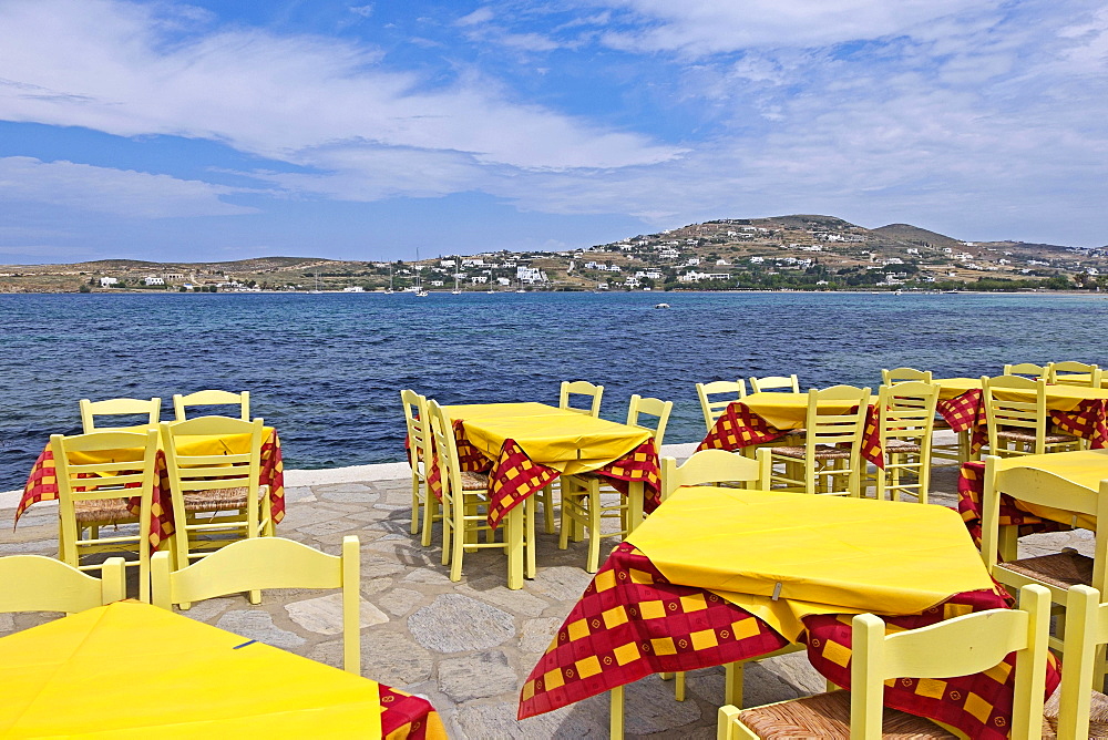 Tables and chairs at a restaurant by the sea, Parikia, Paros Island, Cyclades, Greece, Europe