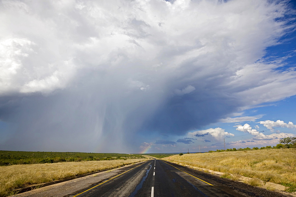 Trans Kalahari Highway, paved road with a rainbow in Namibia, Africa