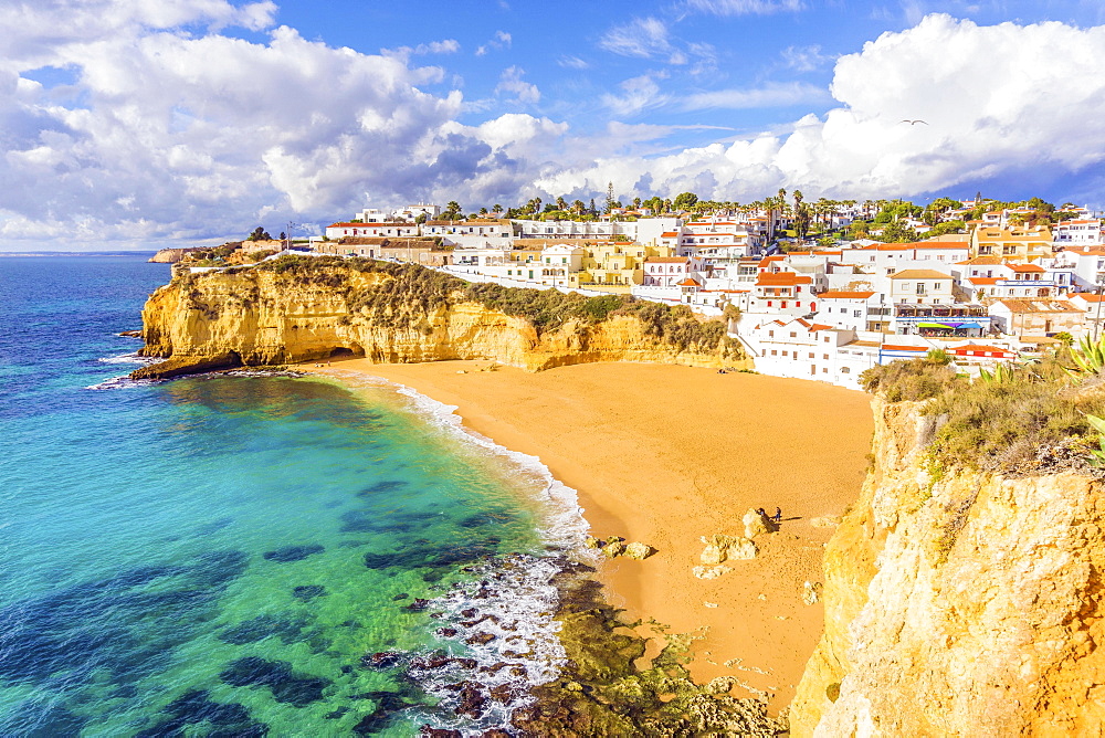 Wide sandy beach, white houses, cloudy sky, Carvoeiro, Algarve, Portugal, Europe