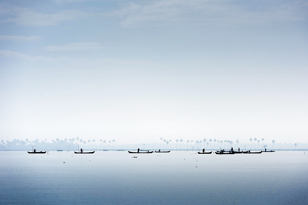 Cockle pickers with their boats, Vembanad Lake, Kerala, India, Asia