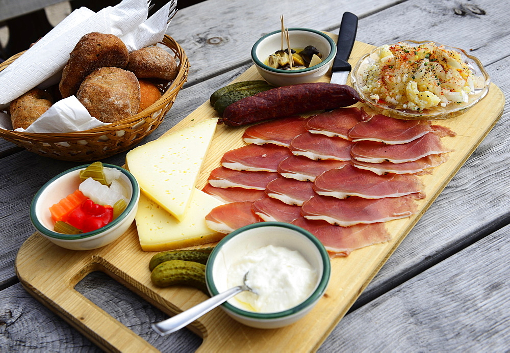 Snack plate with bacon, salami, gray cheese and horseradish on the Rossalm, Braies, Sexten Dolomites, South Tyrol, Italy, Europe