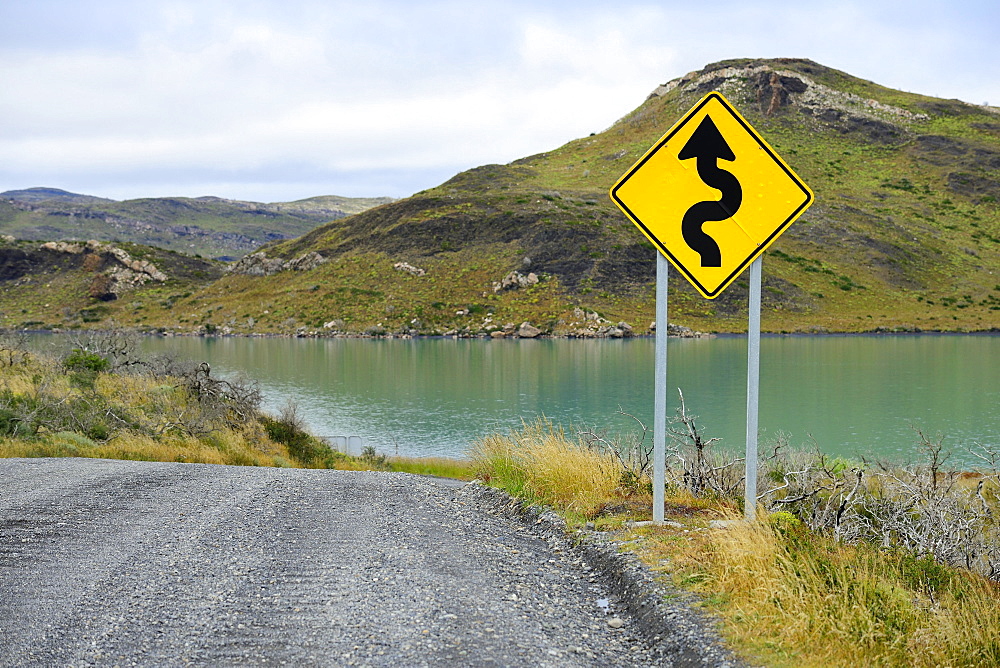 Sign Attention curves along the natural road, Laguna Amarga, Torres del Paine National Park, Última Esperanza Province, Chile, South America