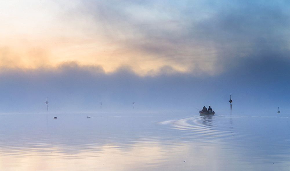 Fishing boat on the mist-shrouded Untersee, Radolfzell, Baden-Wurttemberg, Germany, Europe