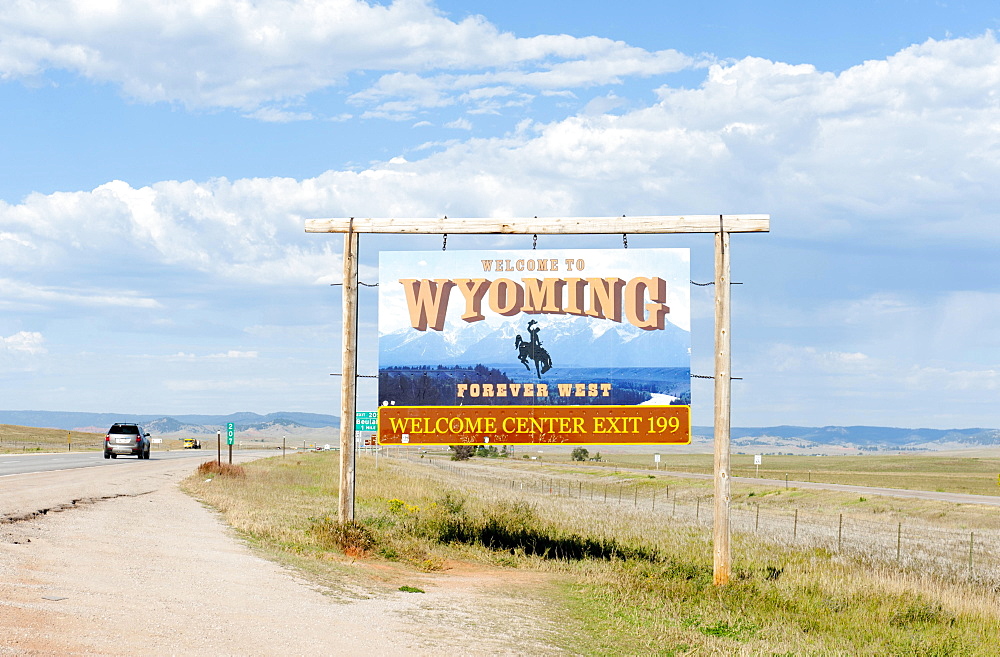 Welcome sign on a highway, ""Welcome to Wyoming, Forever West"", flat landscape, Wyoming, USA, North America