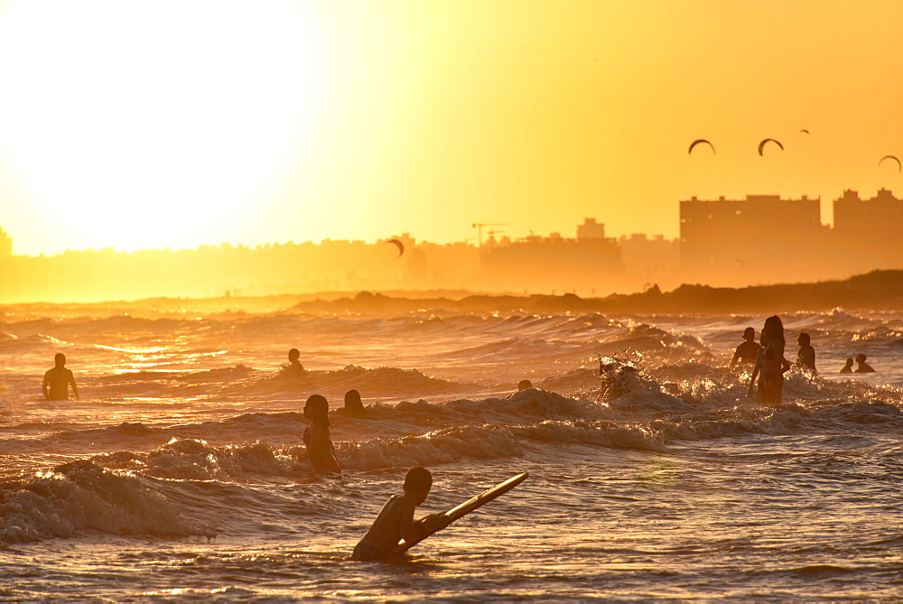 People bathing on the beach at sunset, beach Rambla, Montevideo, Uruguay, South America