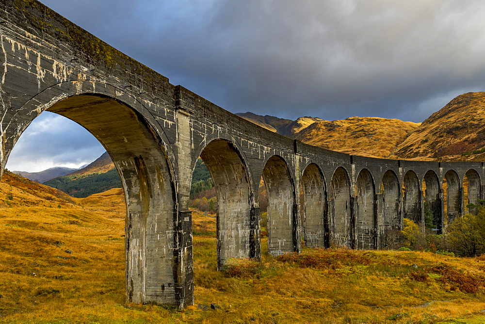 Glenfinnan railway viaduct, with autumn colours and cloudy sky, Glenfinnan, West Highlands, Scotland, Great Britain