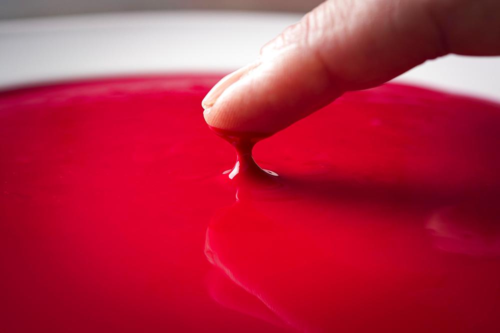 Block printing, finger checking consistency of red color on plate, Bad Aussee, Styria, Austria, Europe