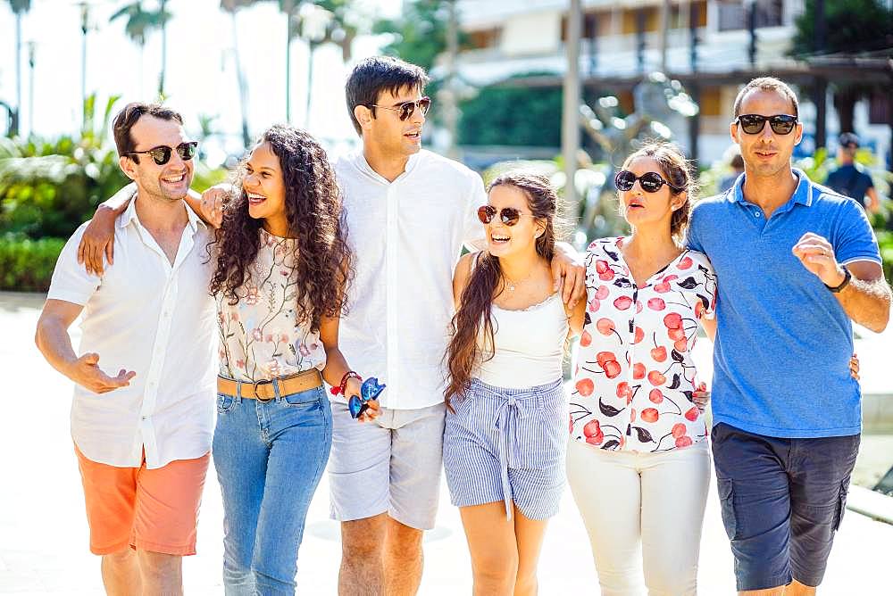 Six friends walking, taking, laughing and having fun during day time in urban setting, Portugal, Europe