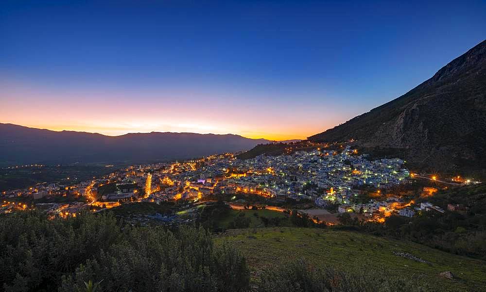 View of illuminated city Chefchaouen at sunset, Chaouen, reef mountains, Tangier-Tetouan, Morocco, Africa