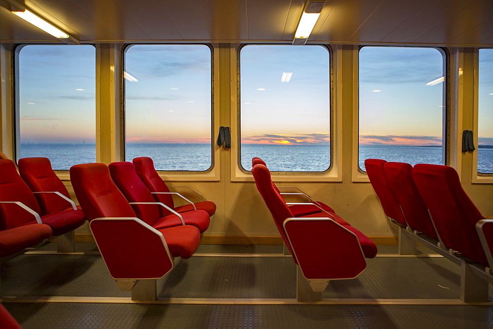 Red benches of a car ferry across the Gironde at sunset, Royan, Medoc, Gironde, France, Europe