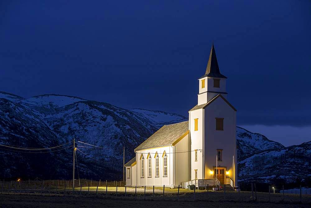 Illuminated church during blue hour, Brensholmen, Tromsoe, Troms, Norway, Europe