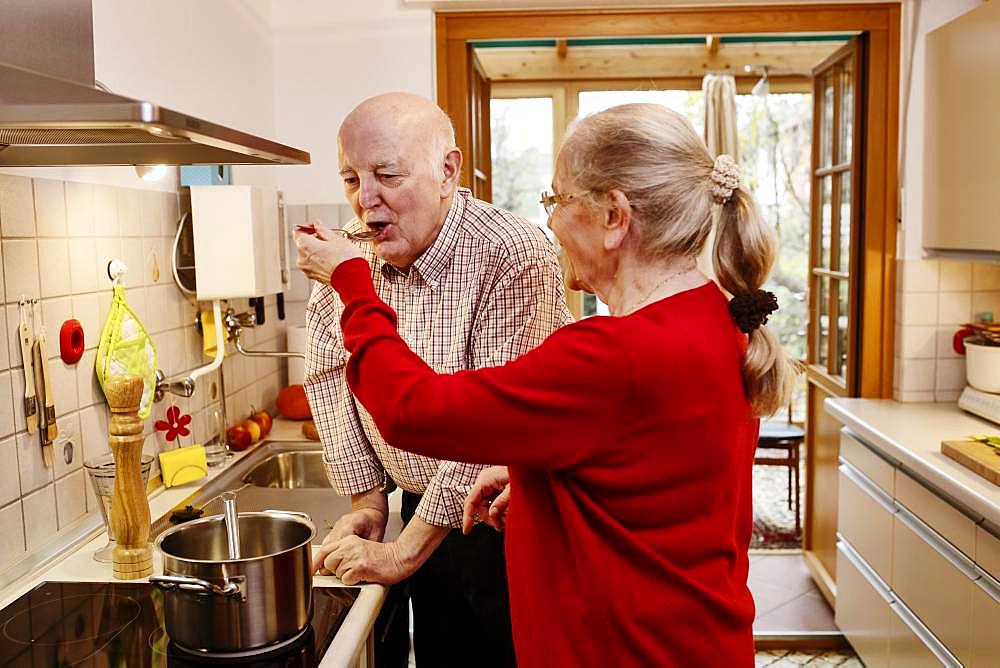 Senior woman lets her man try cooking, Germany, Europe