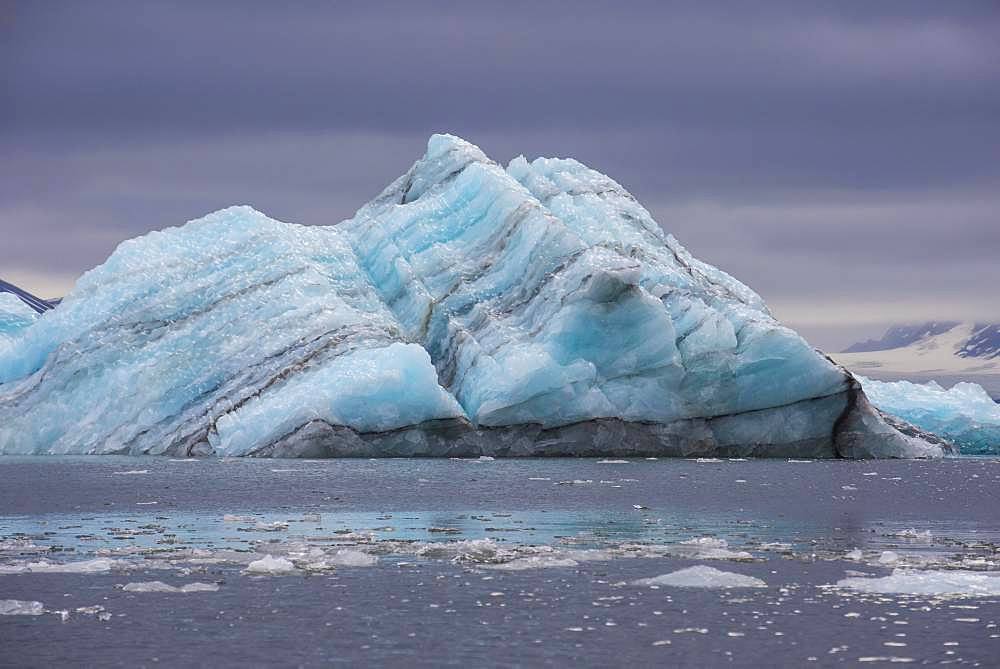 Floating chunk of ice before a huge glacier in Hornsund, Arctic, Svalbard, Norway, Europe