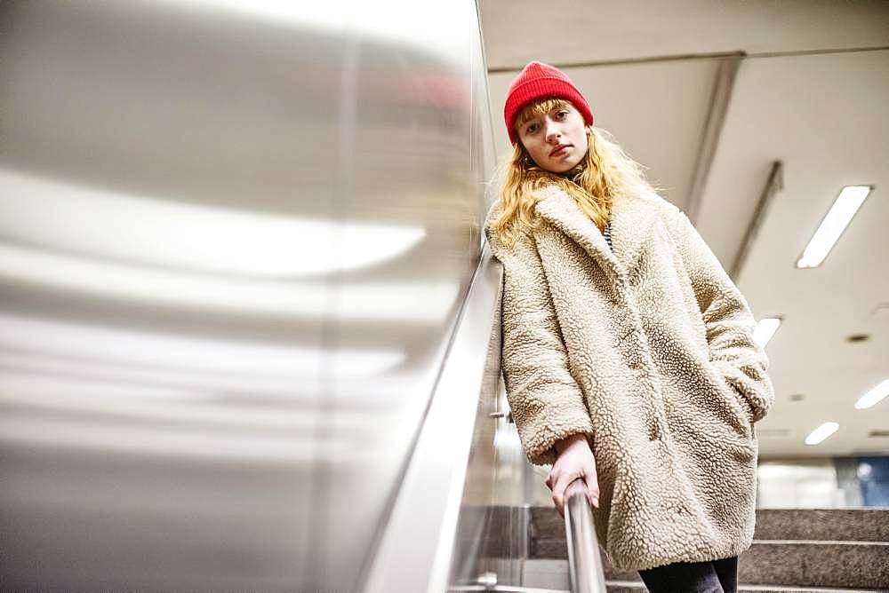 Girl, teenager, standing at the stairs of a subway station, Cologne, North Rhine-Westphalia, Germany, Europe