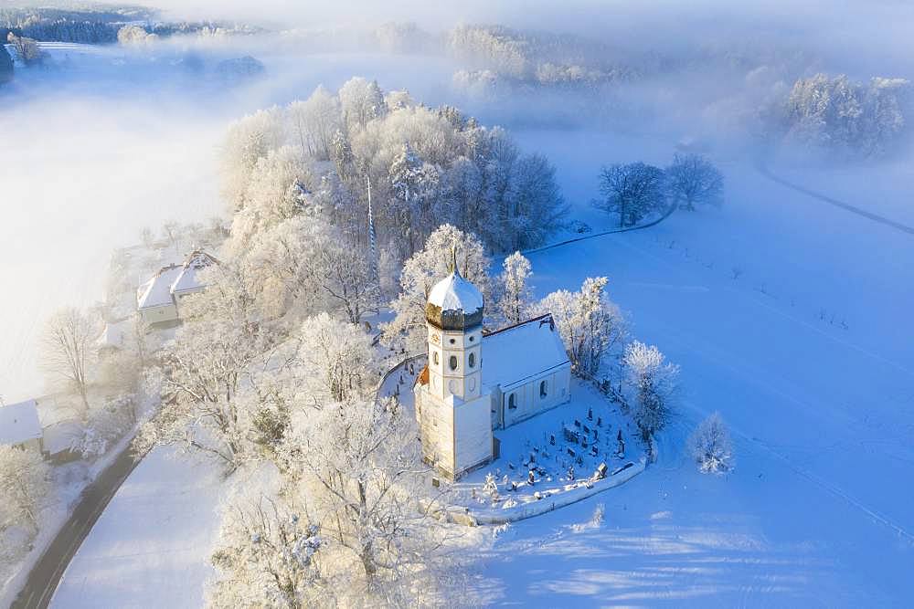 Snow-covered church St. Johann Baptist. Fog mood, Holzhausen near Muensing, Fuenfseenland, drone shot, Alpine foothills, Upper Bavaria, Bavaria, Germany, Europe