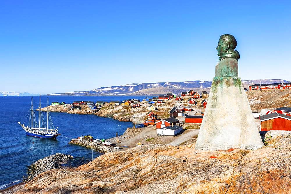 East Greenland town Ittoqqortoormiit with view to the harbour and the statue of Einar Mikkelsen, Scoresbysund, East Greenland, Greenland, North America