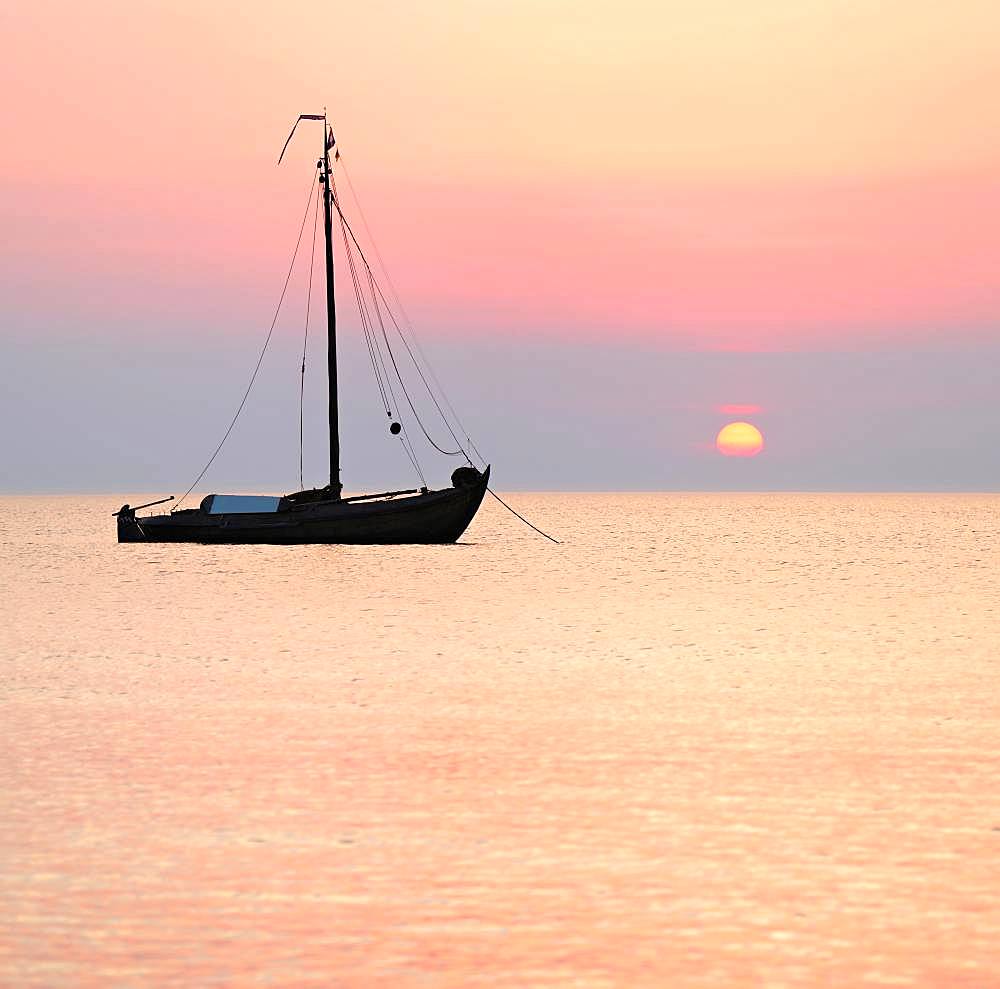 Sunset at the Baltic Sea, traditional sailing boat anchored, West beach, Baltic seaside resort Wustrow, Fischland-Darss-Zingst, Mecklenburg-Western Pomerania, Germany, Europe