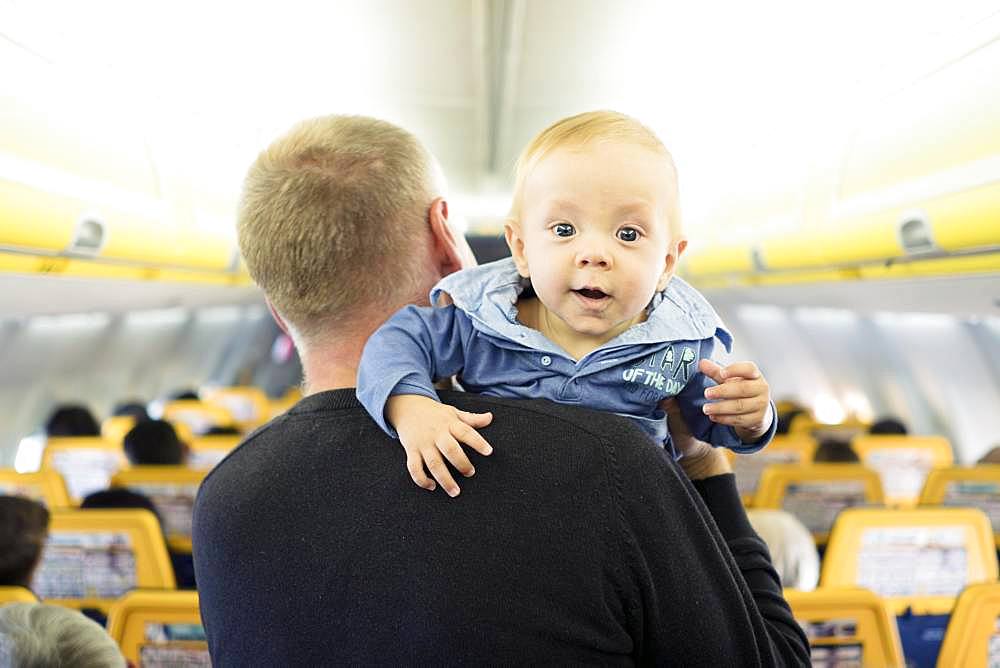 Father with his six months old baby boy in the airplane, Spain, Europe