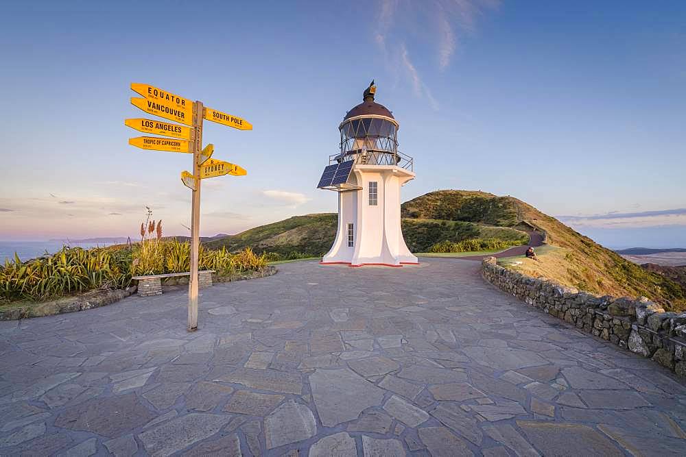 International signpost at the lighthouse at Cape Reinga in evening mood, Far North District, Northland, North Island, New Zealand, Oceania