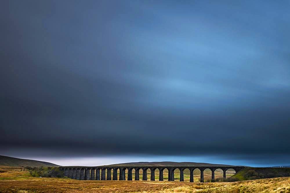 Railway bridge, Ribblehead viaduct in autumn landscape with dramatic cloud sky, Ingelton, Yorkshire Dales National Park, Midlands, Great Britain