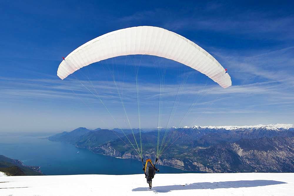 Launch of a paraglider on Monte Baldo above Lake Garda, Malcesine, Veneto, Italy, Europe