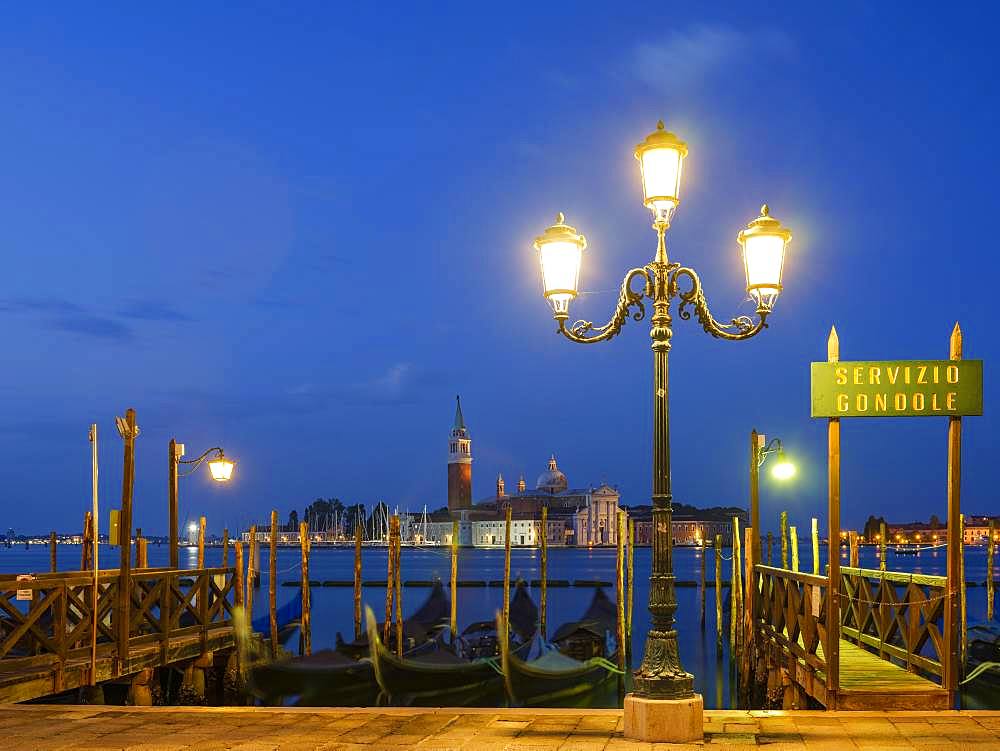 View of the church of San Giorgio Maggiore, in the foreground blue gondolas, Isola di San Giorgio Maggiore, Venice, Veneto, Italy, Europe