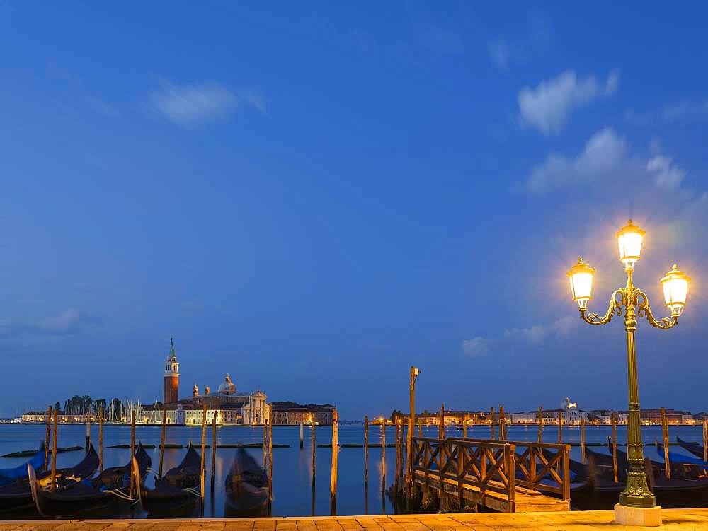 View of the church of San Giorgio Maggiore, in the foreground blue gondolas, Isola di San Giorgio Maggiore, Venice, Veneto, Italy, Europe