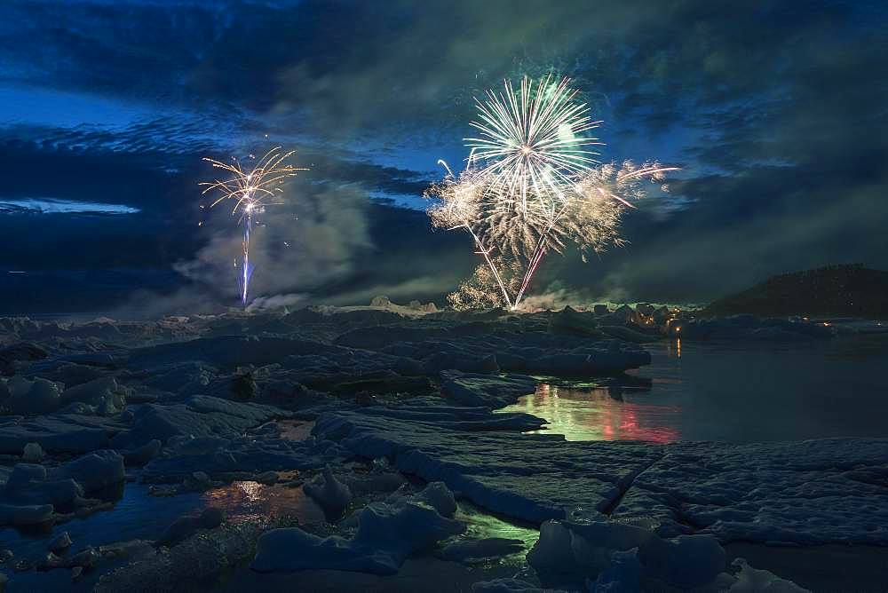 Annual fireworks over the glacier lagoon Joekulsarlon, South Iceland, Iceland, Europe