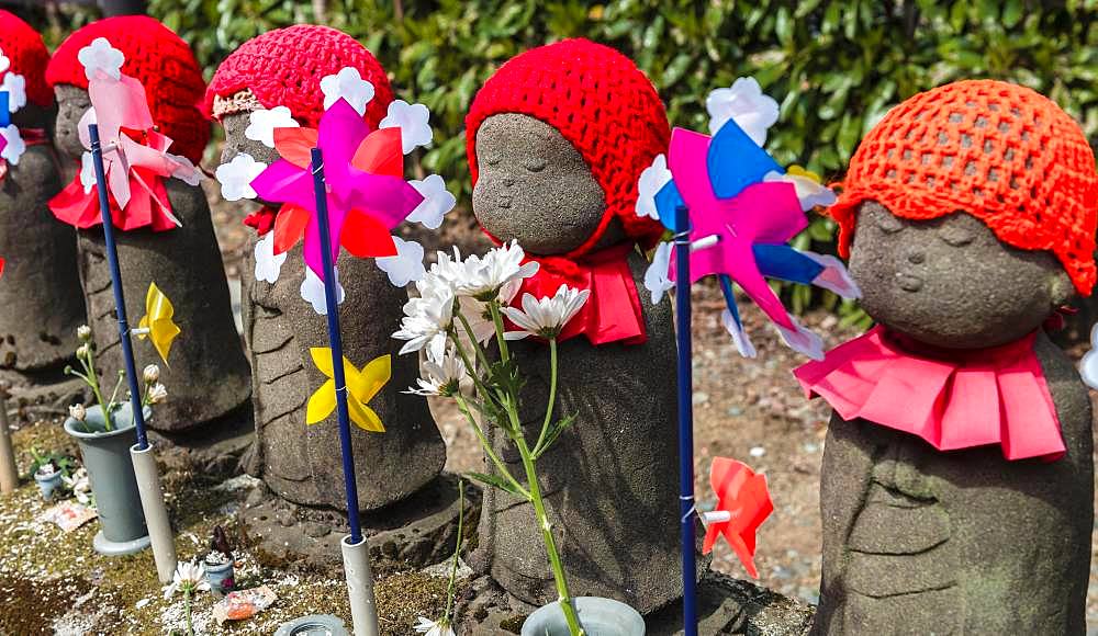 Jizo statues with red caps, protective deities for deceased children, Zojoji Temple, Buddhist temple complex, Tokyo, Japan, Asia