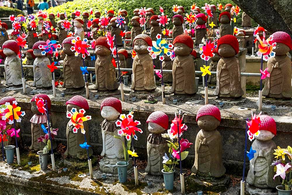 Jizo statues with red caps, protective deities for deceased children, Zojoji Temple, Buddhist temple complex, Tokyo, Japan, Asia