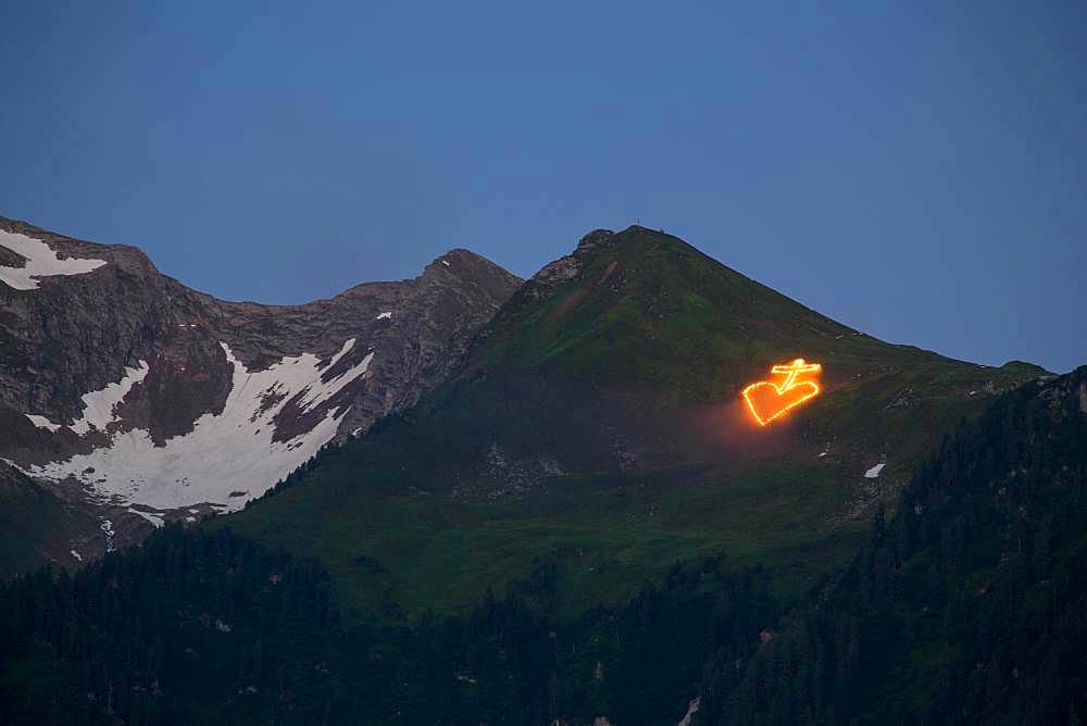 Midsummer Fire on alpine meadow under summit, near Mayrhofen, Zillertal, Tyrol, Austria, Europe