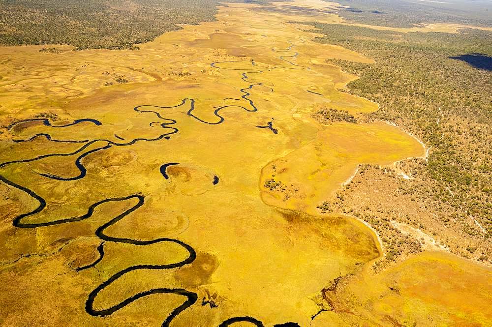 Aerial view, Cubango river meanders through grass savannah, near Cuito Cuanavale, Cuando Cubango Province, Angola, Africa