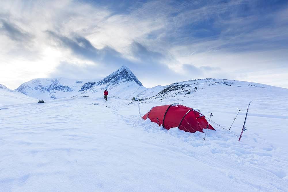 Red tent in the snow, on the long-distance hiking trail Kungsleden, Province of Lapland, Sweden, Europe