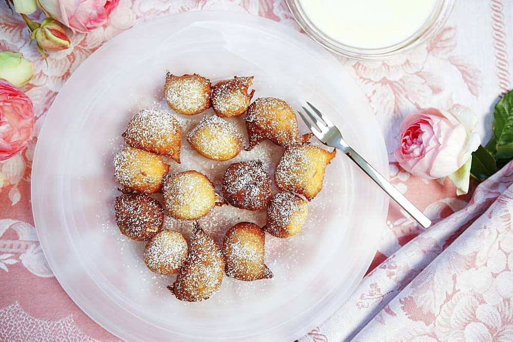 Swabian dessert, Nonnenfuerzle, fat baked with vanilla sauce, lard biscuits, plate, cake fork, roses, Germany, Europe