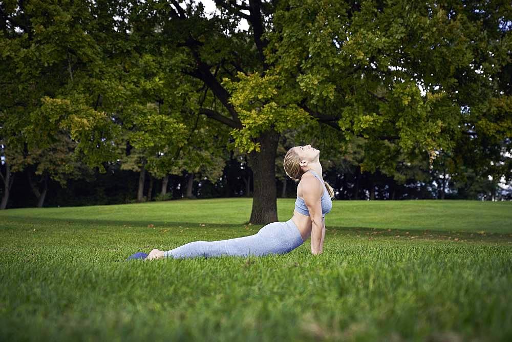 Young woman doing yoga in the park, gymnastics, Olympiapark, Munich, Germany, Europe