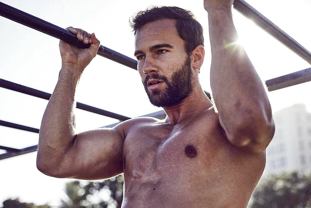 Young man training, pulling up, outdoor sports, Cape Town, South Africa, Africa