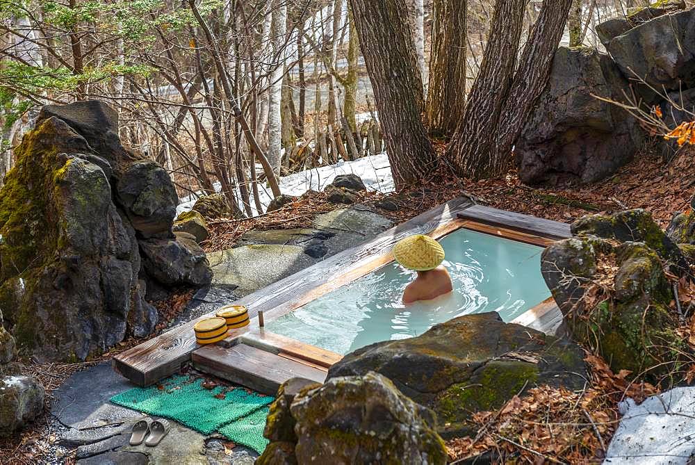 Woman bathing in an onsen, hot thermal spring of a guesthouse, Matsumoto, Japan, Asia