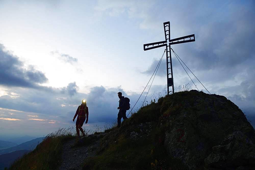 Hikers at dawn on the summit of the Feldalphorn, Kelchsau, Kitzbuehel Alps, Tyrol, Austria, Europe