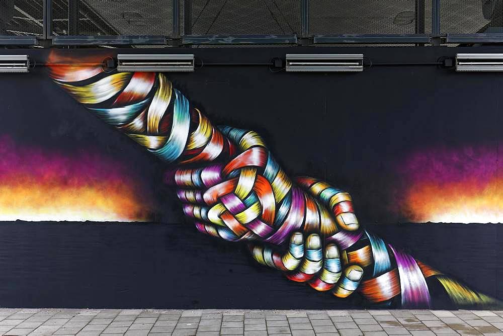 Two hands grab each other by the arm, pulling in the opposite direction, symbolic mural by streetart artist Otto Schade, 40 Grad Urban Art Festival 2019, Duesseldorf, North Rhine-Westphalia, Germany, Europe