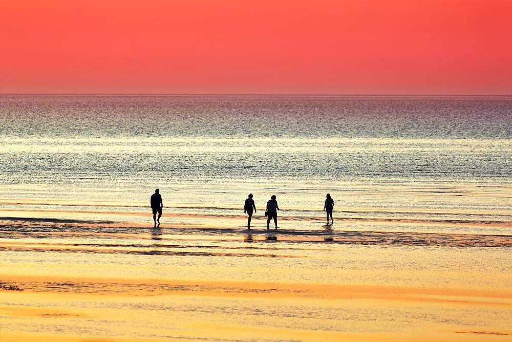 Silhouettes of people on the beach in the water at sunset, North Sea, Lower Saxony, Germany, Europe