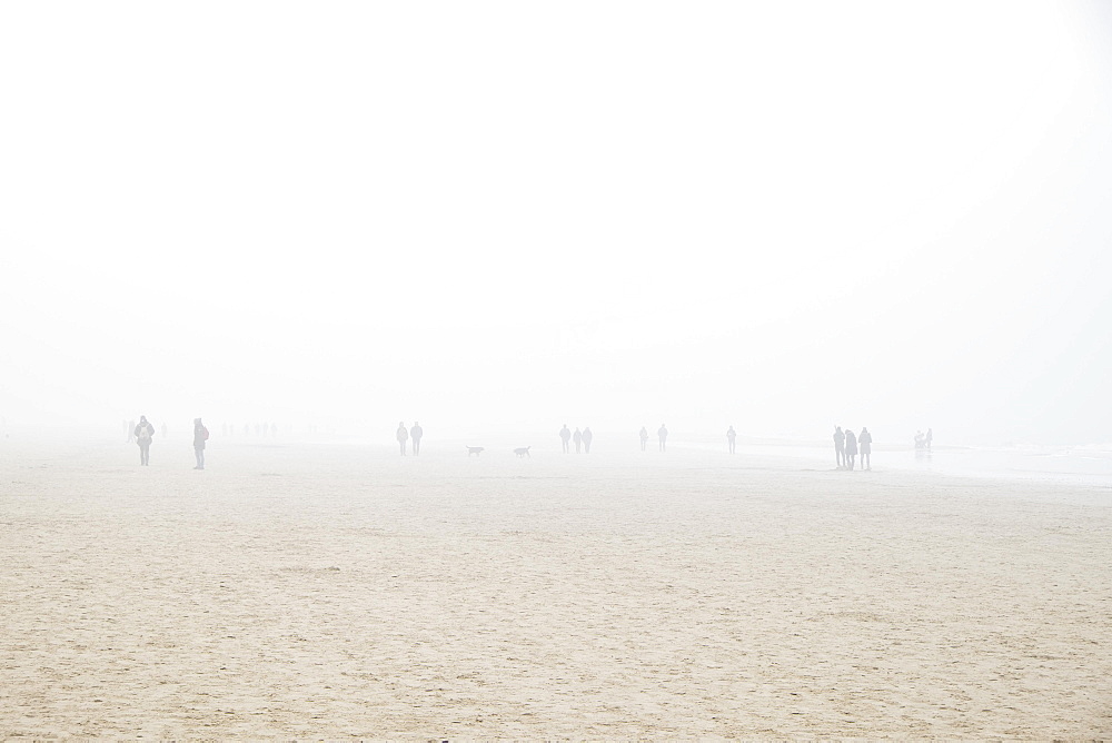 Beach with people in fog, Egmond aan Zee, Netherlands