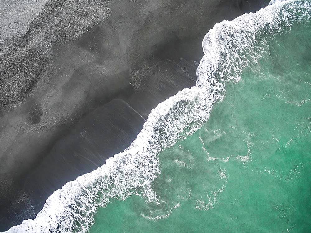 Waves on the beach, turquoise sea and black sand beach, aerial view, west coast, south island, New Zealand, Oceania