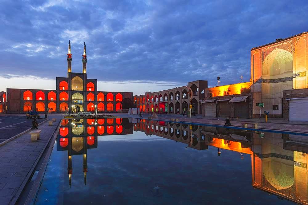 Amir Chaqmaq complex facade illuminated at sunrise and reflecting in a pond, Yzad, Yazd province, Iran, Asia