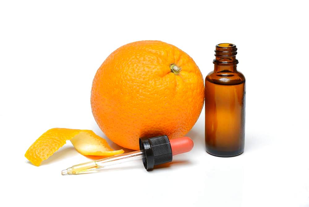 Orange and orange oil in bottle with pipette, Germany, Europe