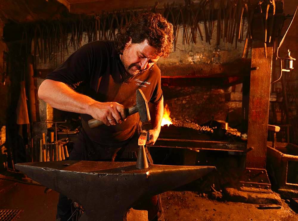 Blacksmith at the anvil, hammer mill Burghausen, Upper Bavaria, Bavaria, Germany, Europe