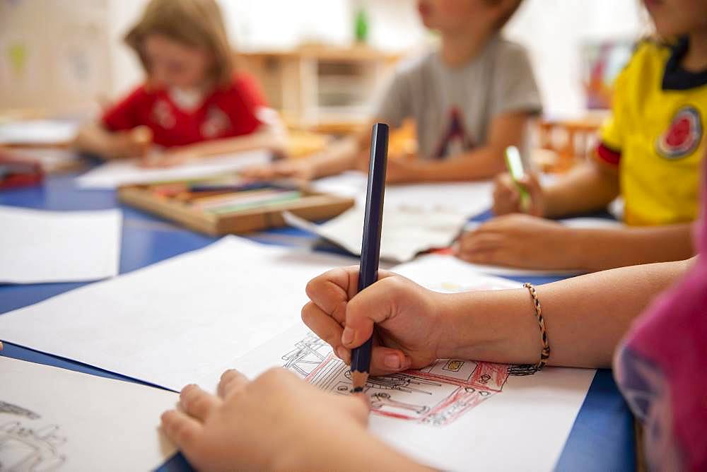 Children painting in kindergarten with crayons, Cologne, North Rhine-Westphalia, Germany, Europe