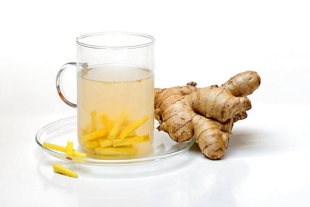 Ginger tea in glass and ginger root, Germany, Europe