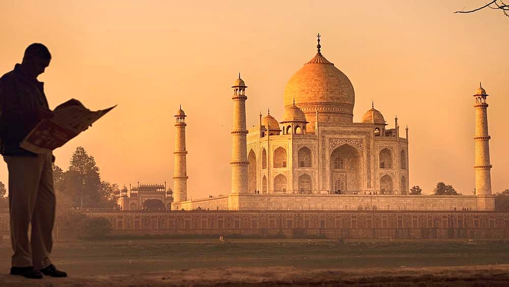 Silhouette of a man reading a newspaper, Taj Mahal monument, Agra, India, Asia