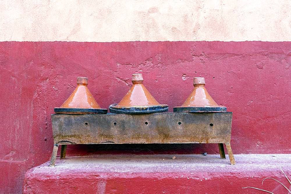 Three clay tagine pots on portable barbeque, Morocco, Africa