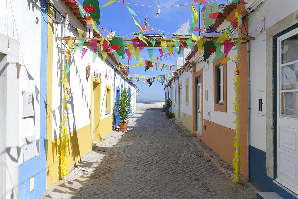 Narrow village Street decorated with flags in the old city of Alcochete, Setubal Province, Portugal, Europe